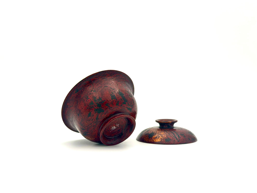 Bottom of Crimson Eclipse gaiwan showing the artisan signature and natural lacquer texture.