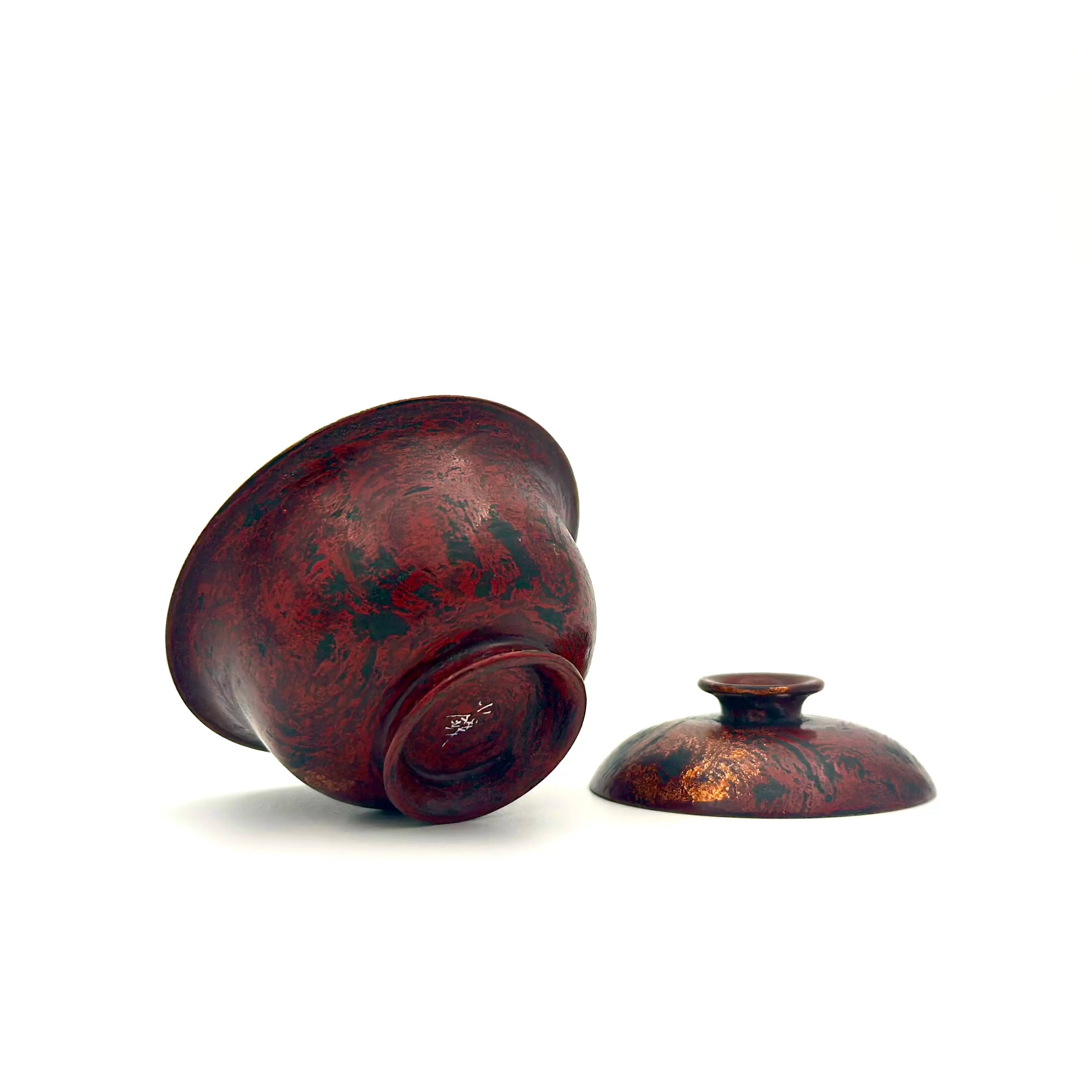 Bottom of Crimson Eclipse gaiwan showing the artisan signature and natural lacquer texture.