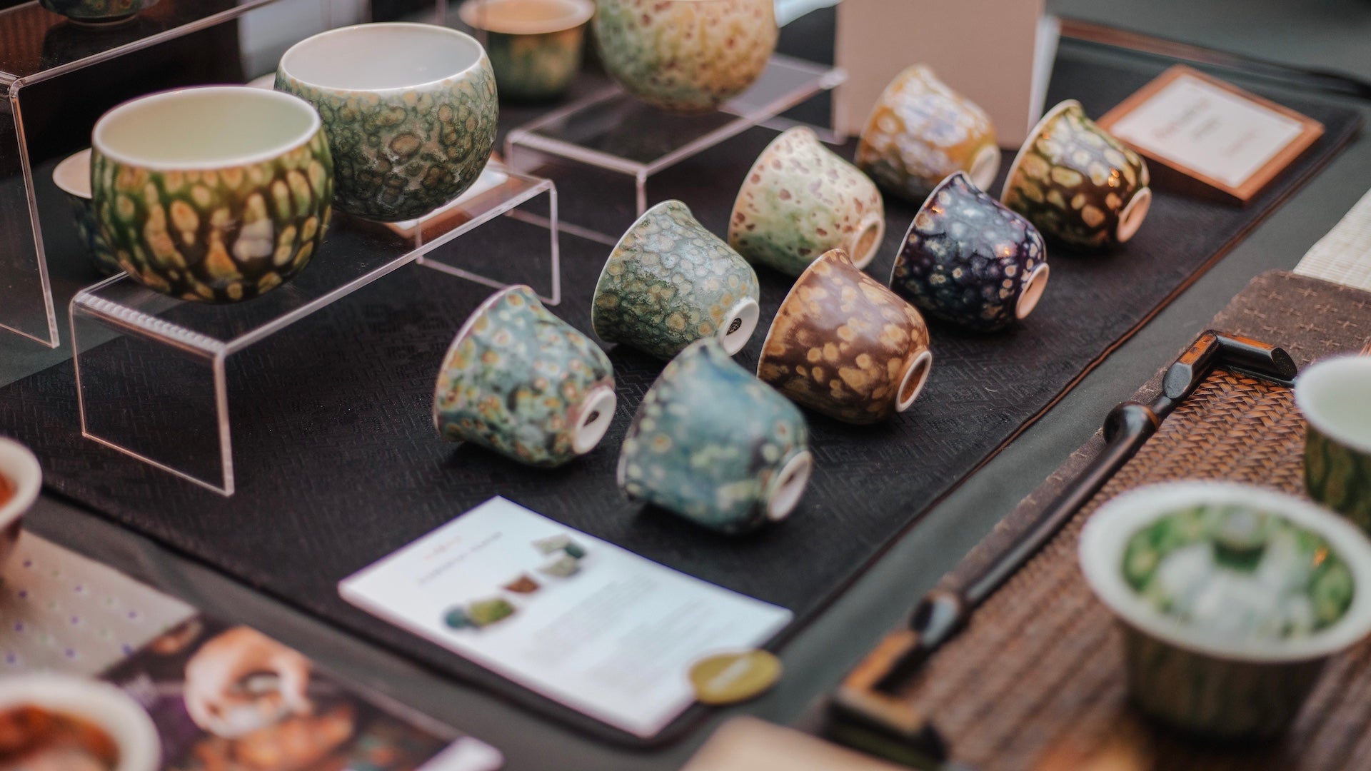 A beautiful booth display of Glazara Elemental teacups showcased at the Amsterdam Tea Festival, highlighting our premium ceramic teaware collection in an authentic event setting.