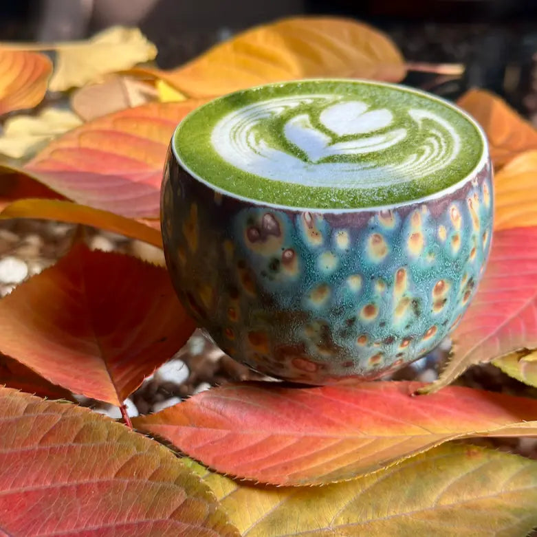 Elegant latte art displayed inside the Glazara Aurora Shore matcha latte cup, showcasing its wide café-style bowl and the ethereal, gradient ceramic glaze inspired by coastal morning skies.