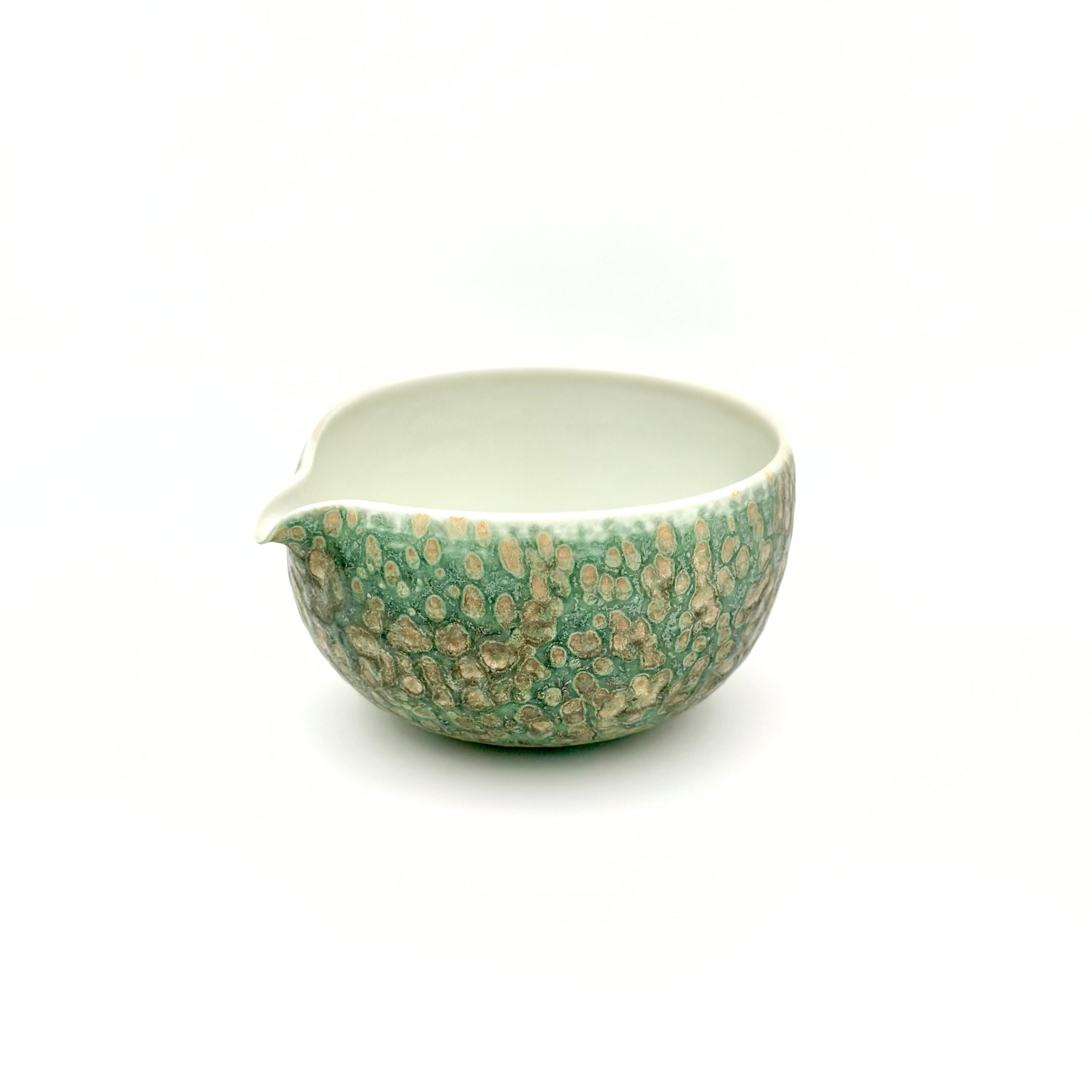 Angled view of the Emerald Drift artisan matcha bowl, highlighting the wide, gently curved mouth and smooth interior wall explicitly designed to provide ample room for whisking ceremonial tea.