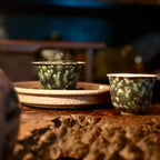 Midsummer Night Gongfu tea set setup: 100ml Gaiwan and matching master teacup resting on a serving tray. Displays the dark, elegant silhouette against a wooden tea table setting.
