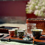 A group of tasting teacups arranged for an outdoor tea session, highlighting the 30ml Glazara Midsummer-Night tasting teacup.