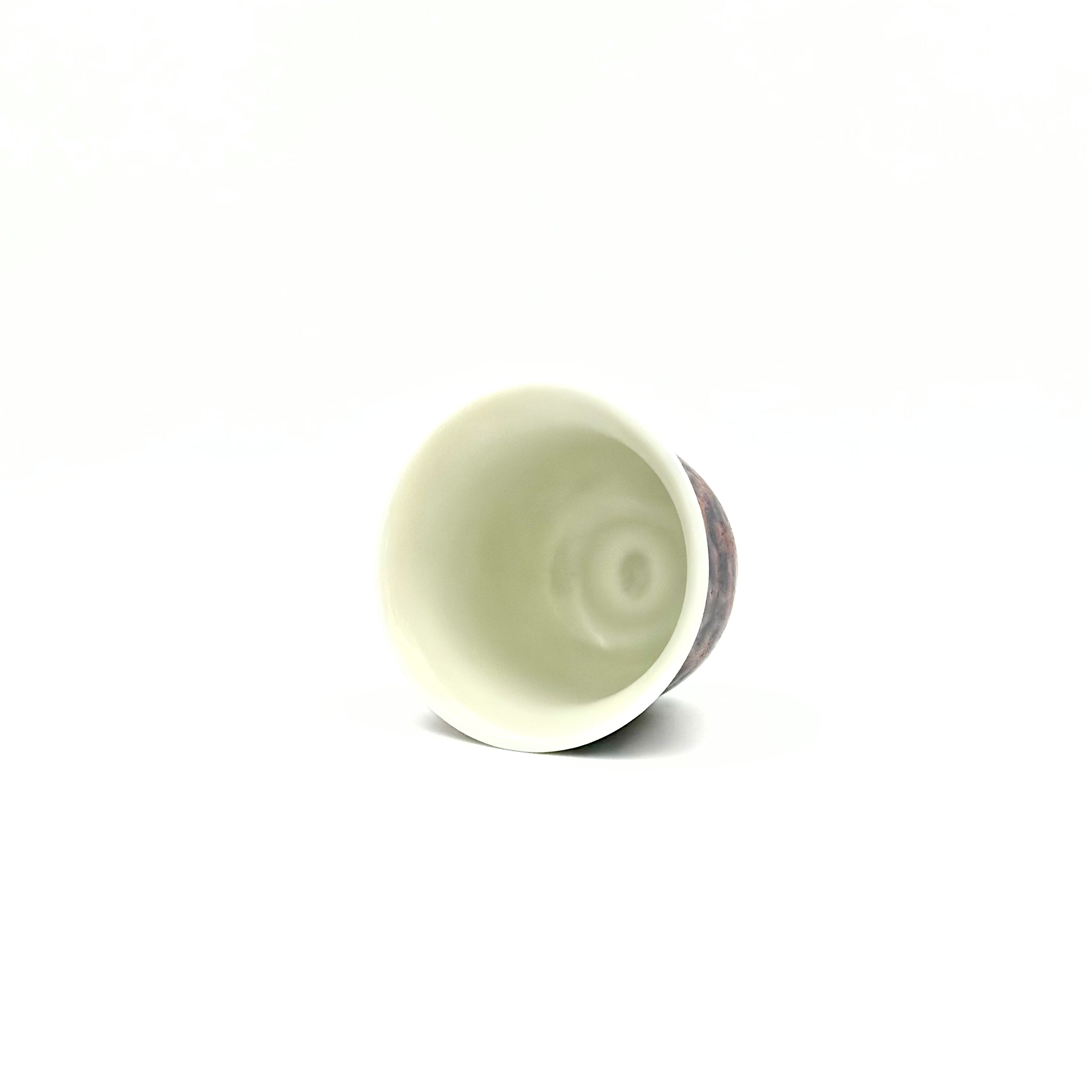Overhead top-down view inside the 70ml Montorgueil Master Teacup, revealing the perfectly smooth, pristine white interior glaze essential for appreciating the true hue and clarity of specialty teas.