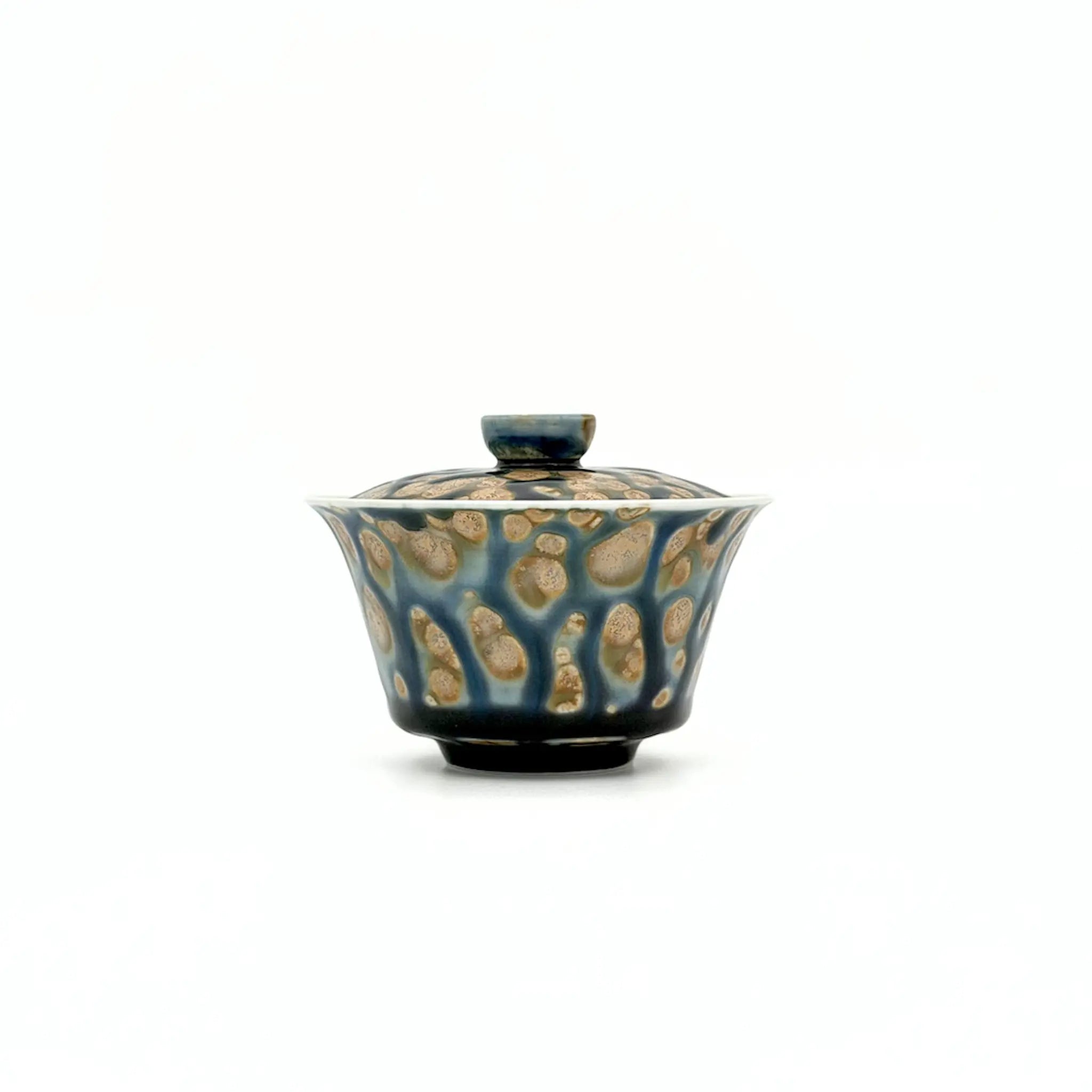Porcelain gaiwan with a textured surface on a white background
