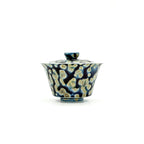 Porcelain gaiwan with minimalist pattern on a white background