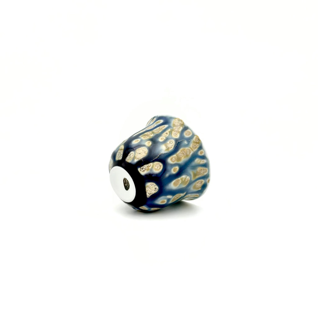 Decorative teacup with blue and gold pattern on a white background