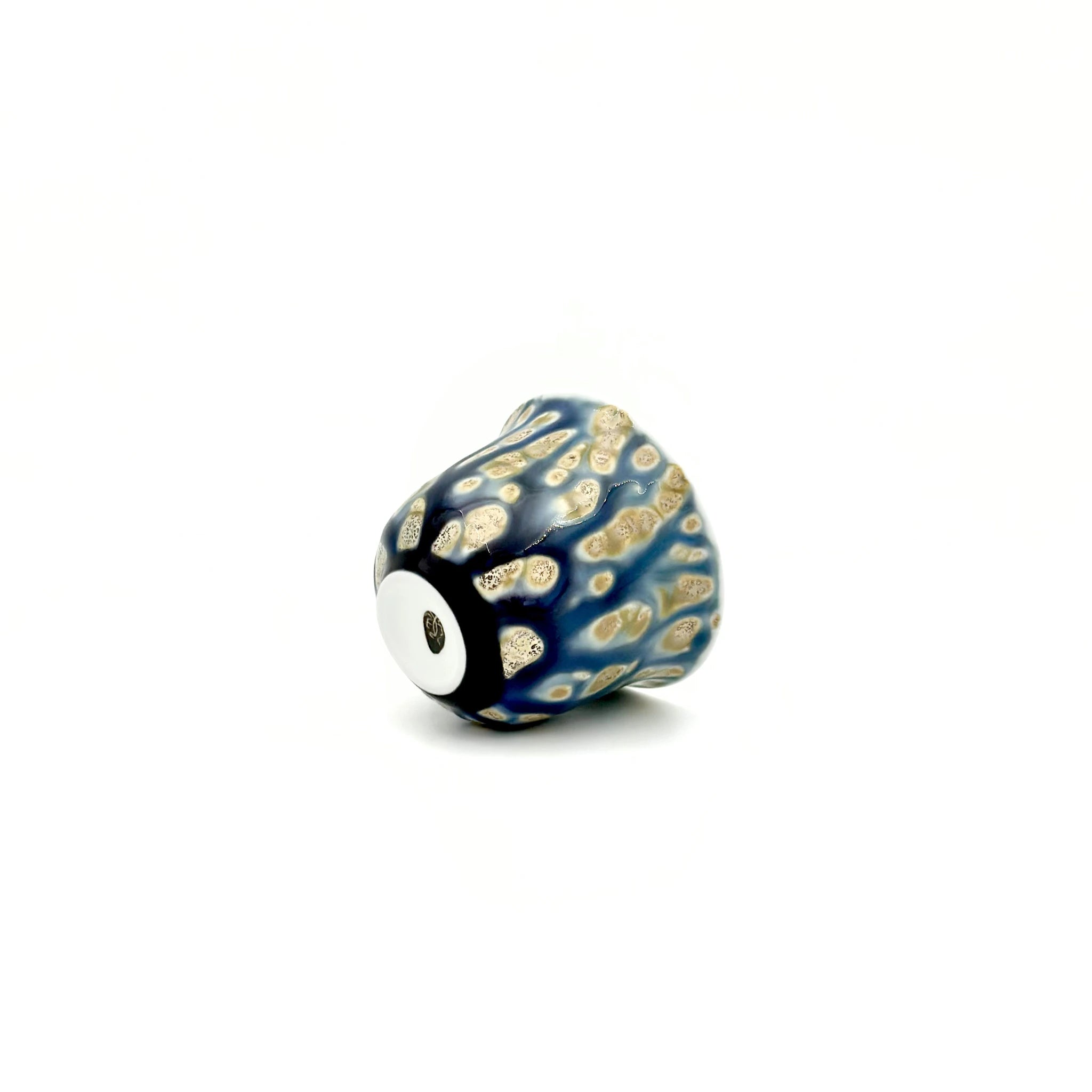 Decorative teacup with blue and gold pattern on a white background