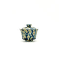 Ceramic gaiwan with lid featuring a blue and gold pattern on a white background