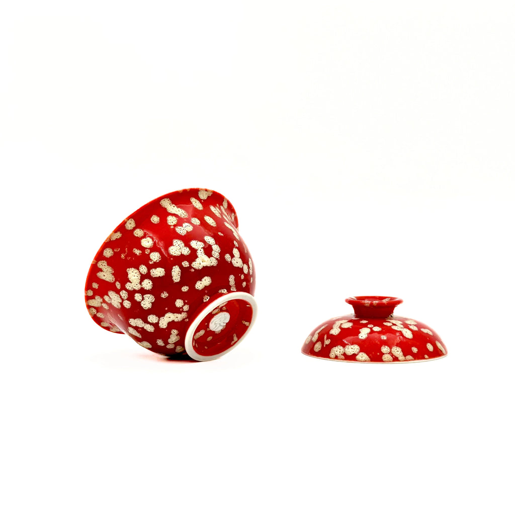 Macro detail of the Phoenix Spark Solo Gaiwan’s base, showcasing the artisan's hallmark stamp and the intricate, ember-like texture of the elemental glaze.