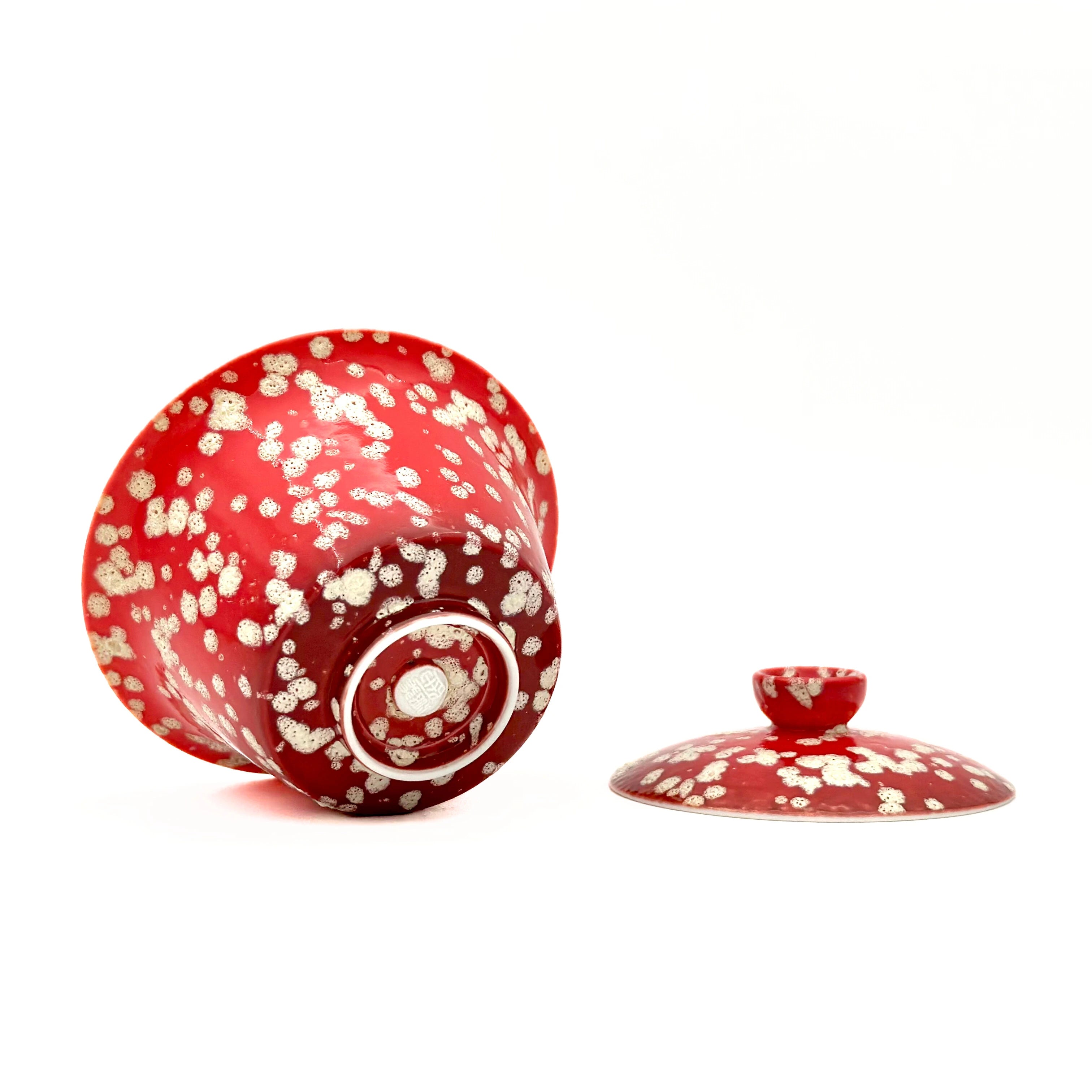 Macro shot of the bottom of the Phoenix Spark Gaiwan, highlighting the authentic artisan stamp and the intricate, crackled glaze texture that resembles glowing embers and sparks.