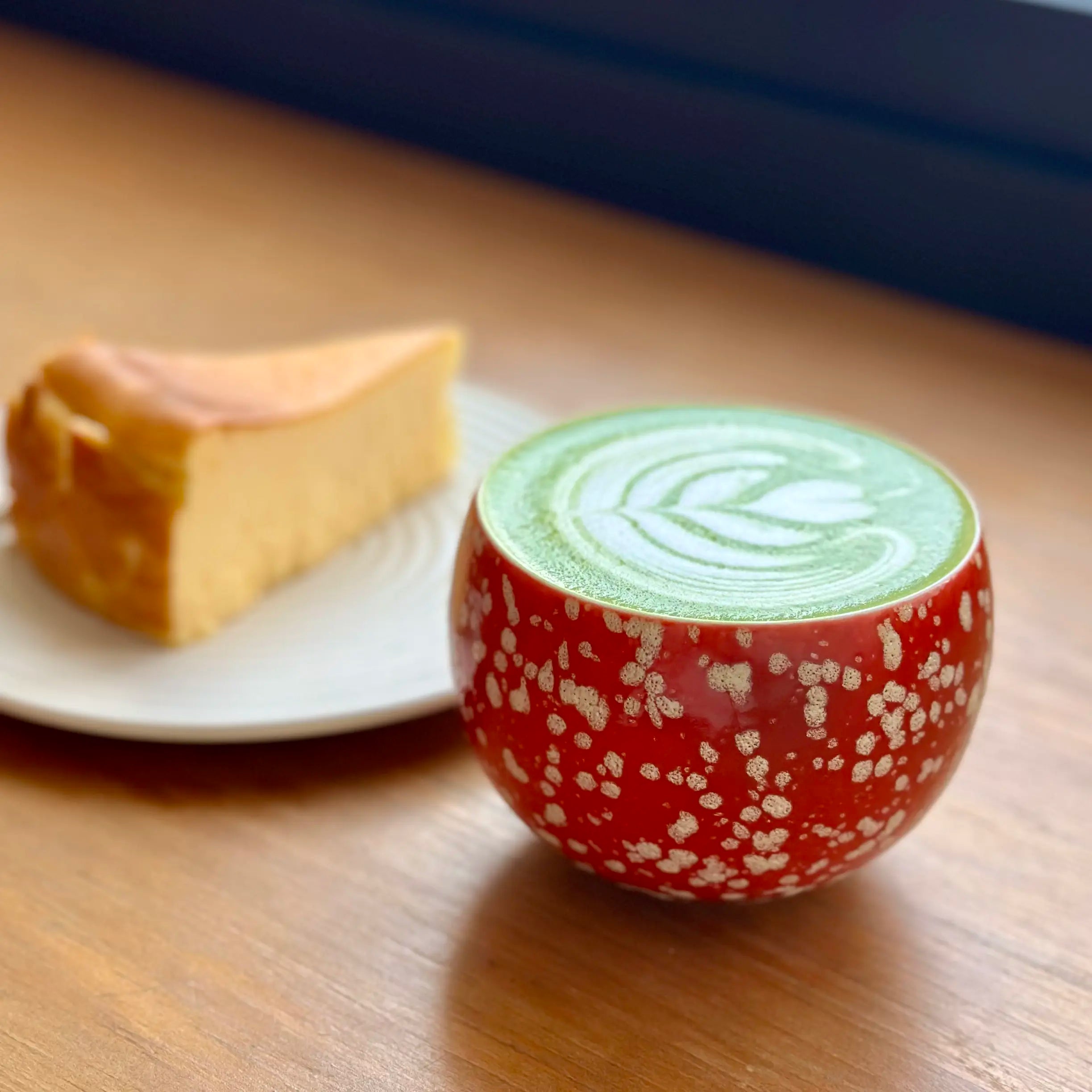 A beautifully poured latte art design inside the Glazara Phoenix Spark matcha latte cup, showcasing its wide, ergonomic bowl-like cup that is perfectly shaped for whisking and serving.