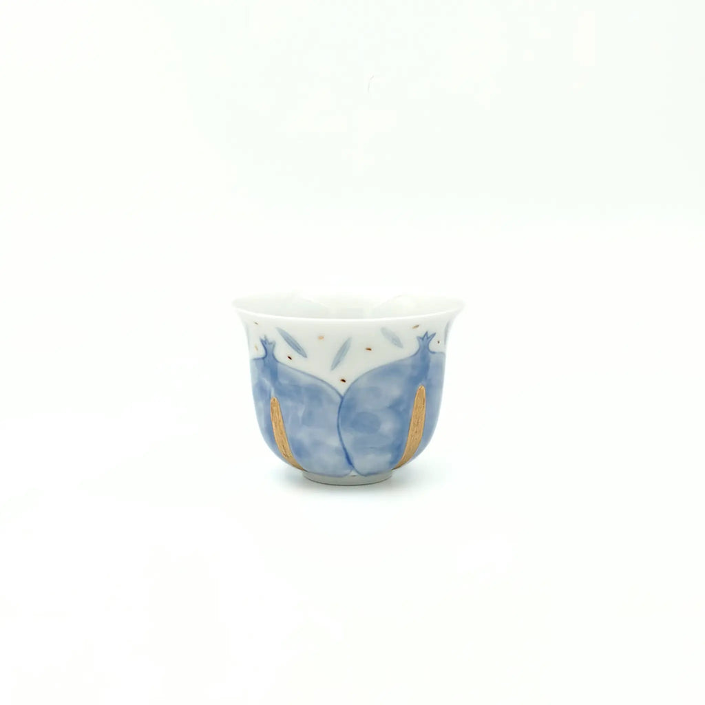 Ceramic cup with blue and gold design on a white background