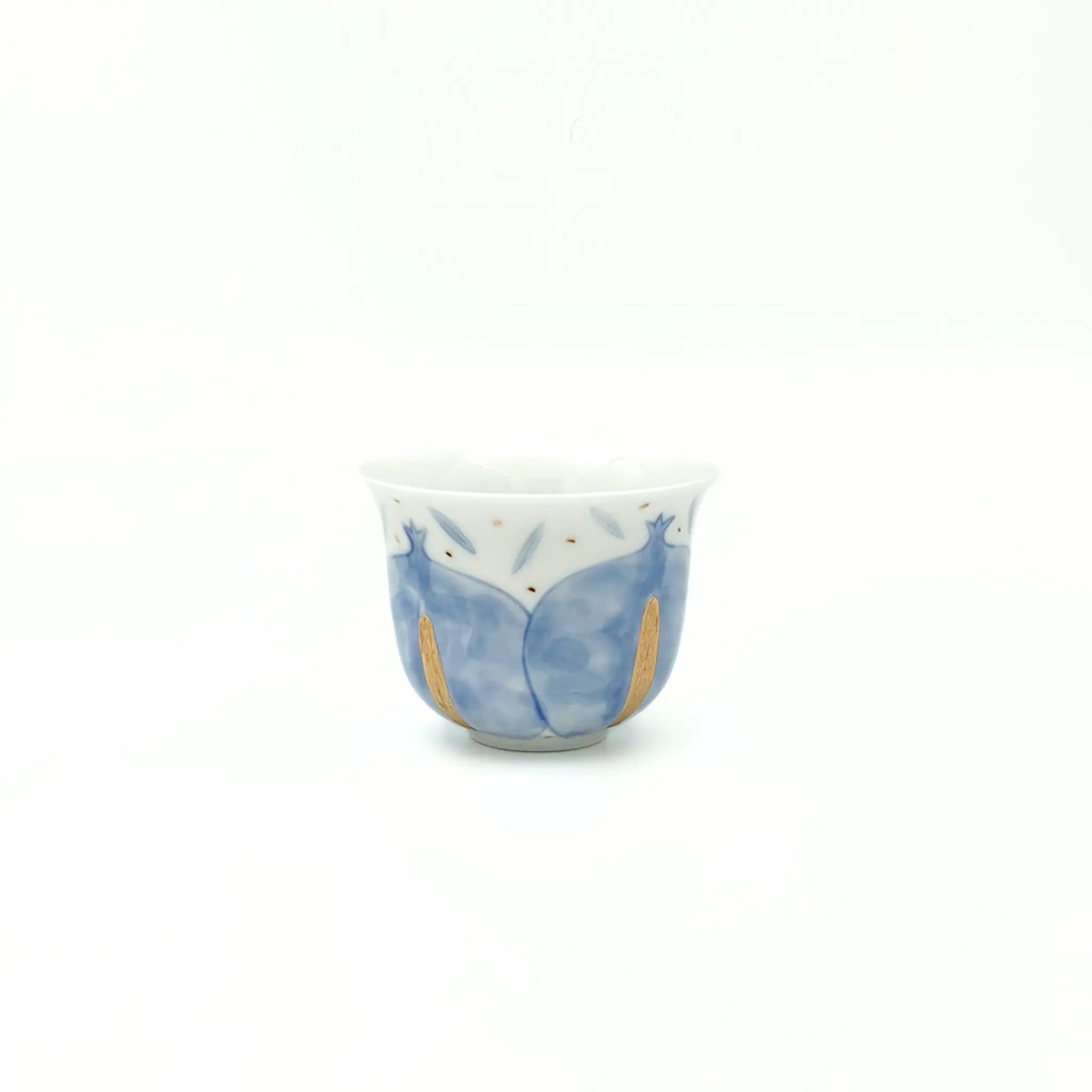 Ceramic cup with blue and gold design on a white background