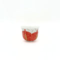 Small ceramic cup with red and gold design on a white background