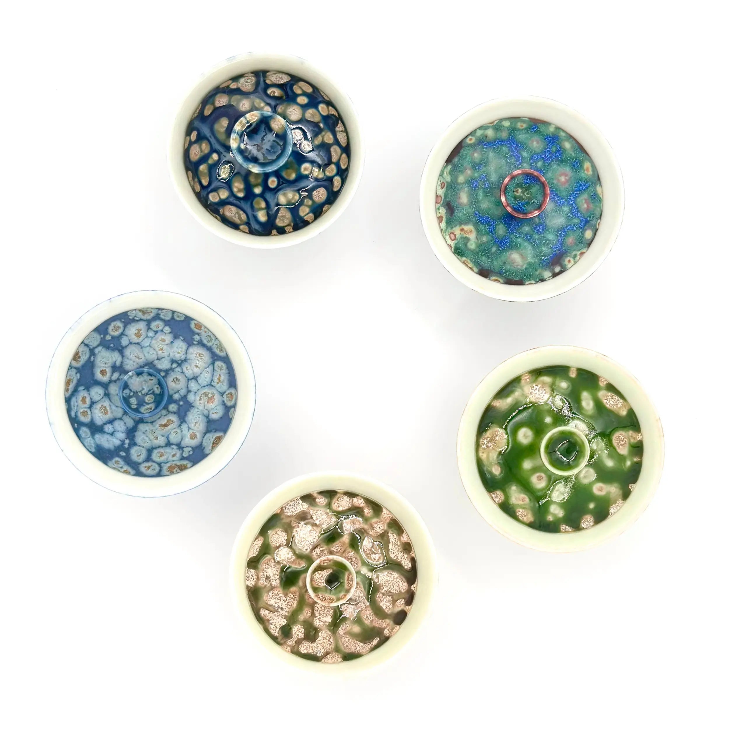 Top-down comparison of the full Glazara Elemental Gaiwan series. Features the Ocean Whisper gaiwan alongside other color variations to showcase the distinct glaze personalities in the collection.