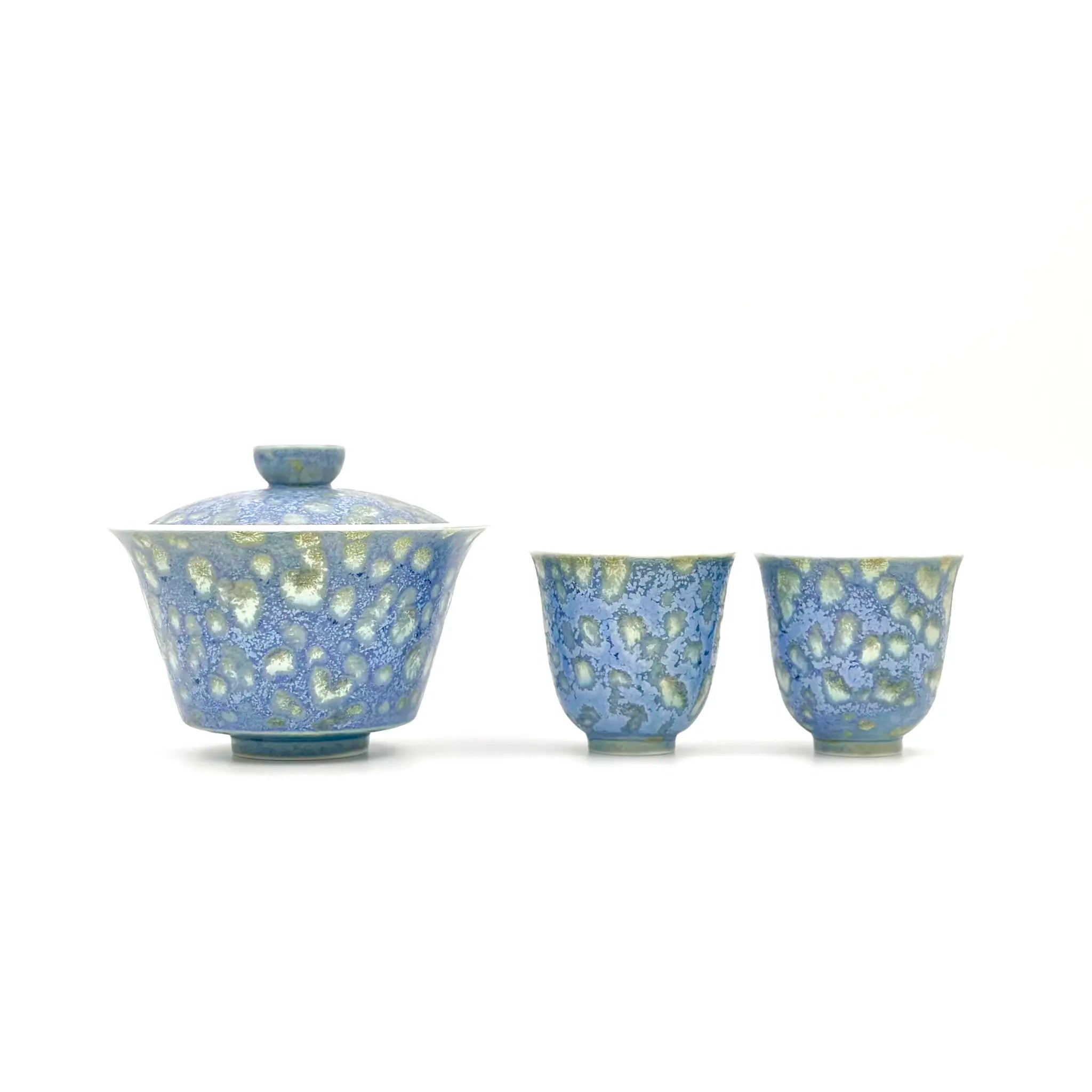 Ceramic teaware set with blue and yellow pattern on a white background