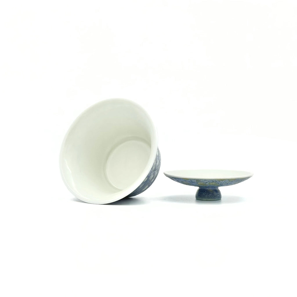Overhead view into the pristine white interior of the 60ml Glazara Promenade Breeze porcelain gaiwan, expertly glazed to perfectly reflect the vibrant color and clarity of specialty tea liquors.