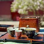 An outdoor tea session setting with multiple tasting cups, showcasing the beautifully crafted 30ml Glazara Velvet Rose tasting teacup and Midsummer Night tasting teacup.