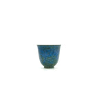 Full front view of the 30ml Glazara Verdant Mirror tasting teacup, featuring a vibrant, reflective green and blue porcelain finish.