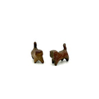 A high-angle view of two standing wood-fired Yixing clay cat tea pets side-by-side, showcasing their unique clay textures and playful companionship.