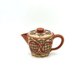Front view of the Ivory Canvas white-slip painted Yixing Zisha teapot, showcasing its elegant curves and ancient Neolithic motifs.