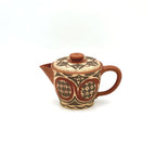 Front view of the Ivory Canvas white-slip painted Yixing Zisha teapot, showcasing its elegant curves and ancient Neolithic motifs.