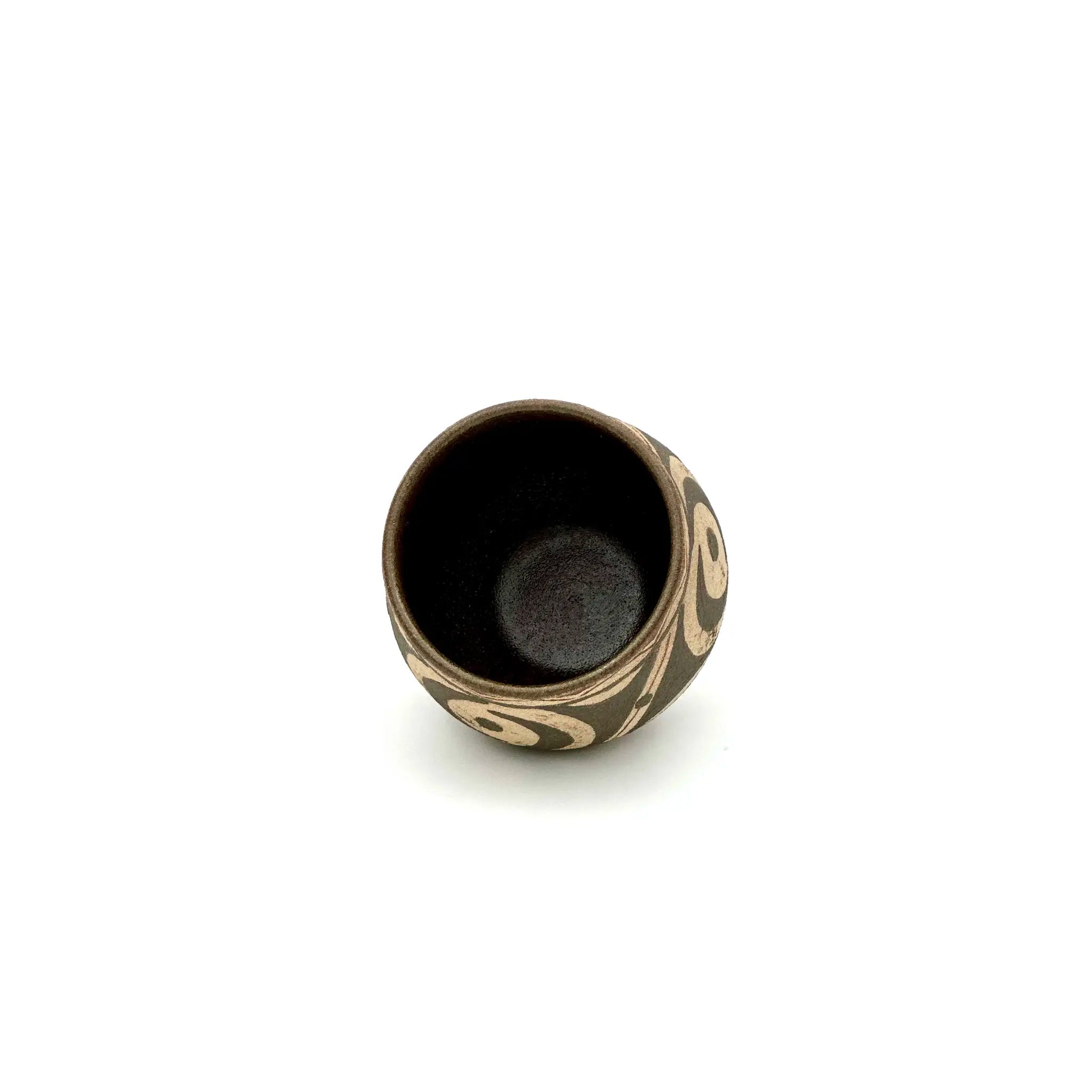 High-angle view looking into the Ivory Canvas Yixing Zisha teacup, highlighting the smooth, glazed interior designed to perfectly hold the tea flavor.