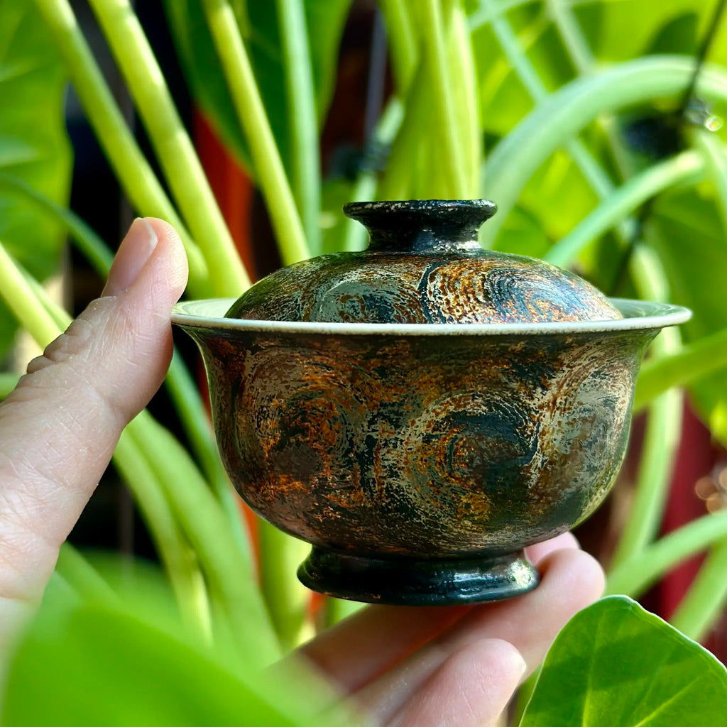 A close up of the 45ml Midnight gaiwan held in hand for a solo tea session.