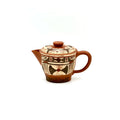 The unpainted base of the Neolithic Echo Yixing teapot, showcasing the authentic artisan's carved signature stamp against the natural Zisha clay.