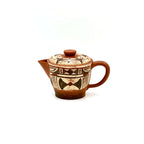The unpainted base of the Neolithic Echo Yixing teapot, showcasing the authentic artisan's carved signature stamp against the natural Zisha clay.