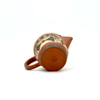 The unpainted base of the Neolithic Echo Yixing teapot, showcasing the authentic artisan's carved signature stamp against the natural Zisha clay.