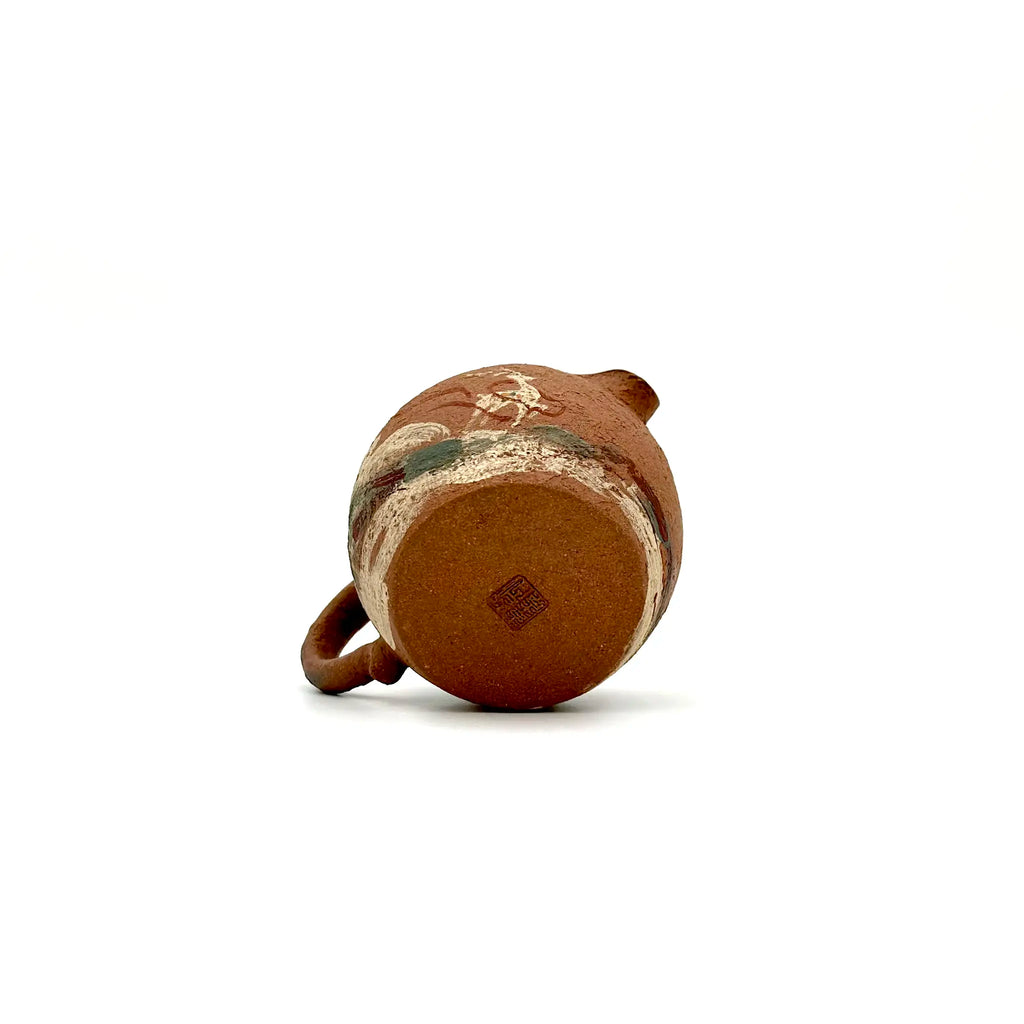The unpainted base of the Nine-Colored Deer Yixing Fairness Cup, revealing the natural raw clay texture and the authentic artisan's carved signature stamp.