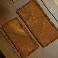 A side-by-side size comparison of the small and medium handcrafted persimmon-dyed tea mats, viewed from above to highlight their natural dye variations and dimensions.