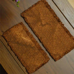 A side-by-side size comparison of the small and medium handcrafted persimmon-dyed tea mats, viewed from above to highlight their natural dye variations and dimensions.