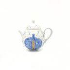 Ceramic teapot with blue pomegranate design on a white background