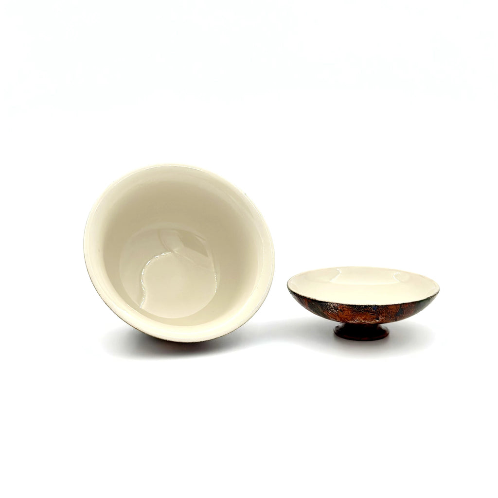 showcasing the interior glaze of an urushi gaiwan on a white background.