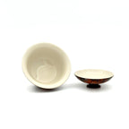 showcasing the interior glaze of an urushi gaiwan on a white background.