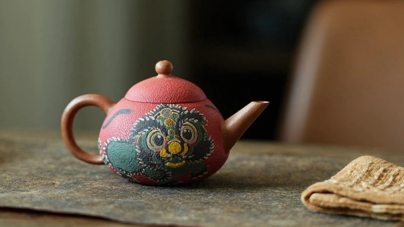 Decorative teapot with a colorful design on a wooden surface